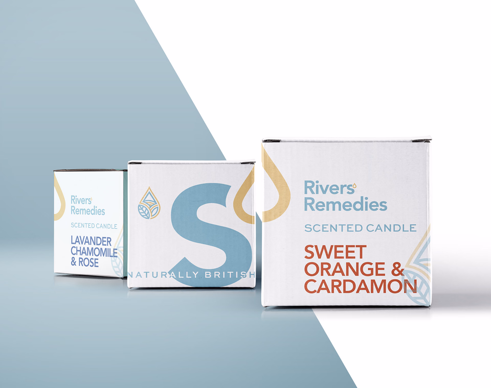 Rivers’ Remedies candle packaging arranged across a pale blue and white field.